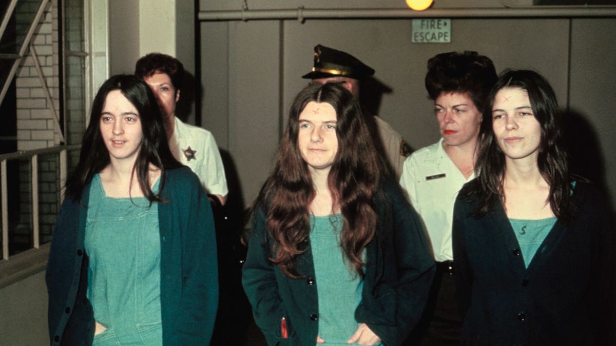 Susan Atkins, Patricia Krenwinkle and Leslie van Houton stand together.