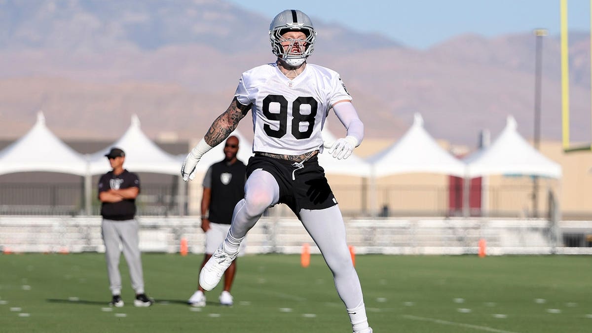 Maxx Crosby warms up during practice at Raiders training camp.