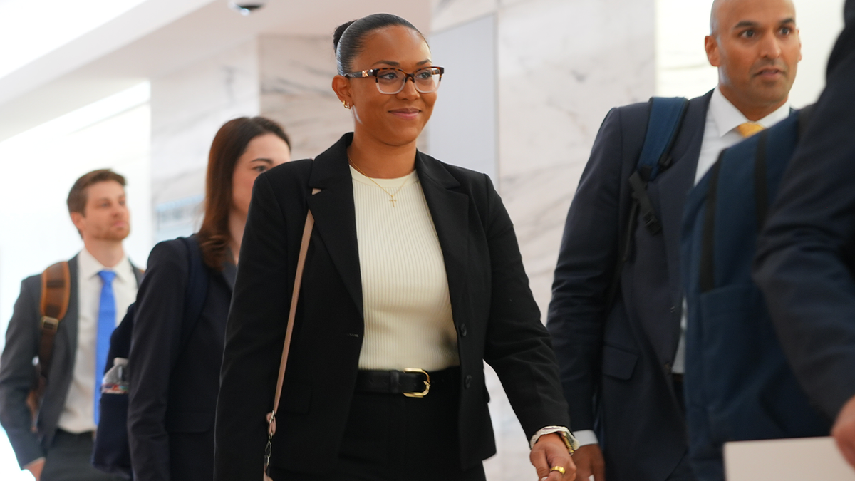 McKenna West arrives at a Dallas courthouse with members of her legal team