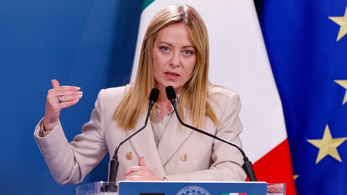 Italy’s prime minister delivers remarks at a podium during a diplomatic event.