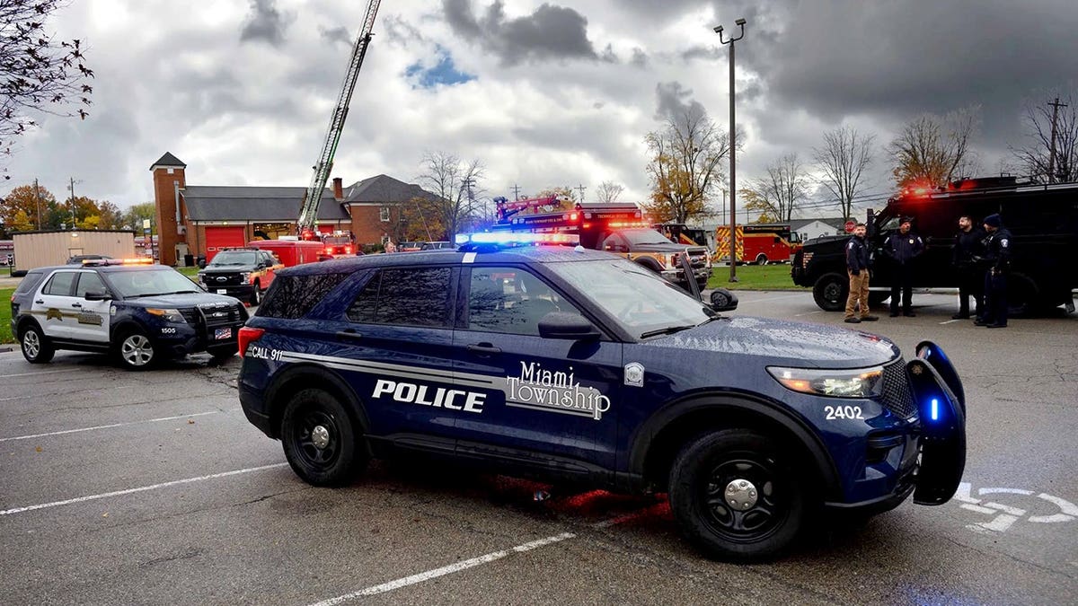 First responders stand near emergency vehicles during a rescue response.