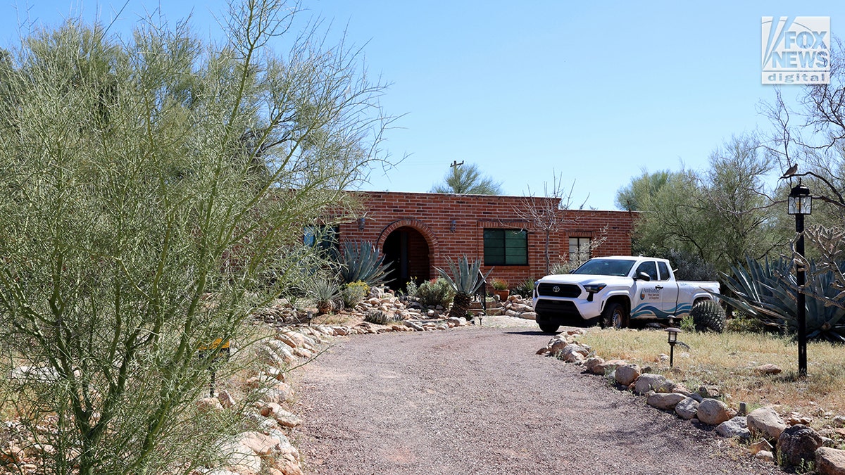 A pool service worker walking toward Nancy Guthrie's residence in Tucson.