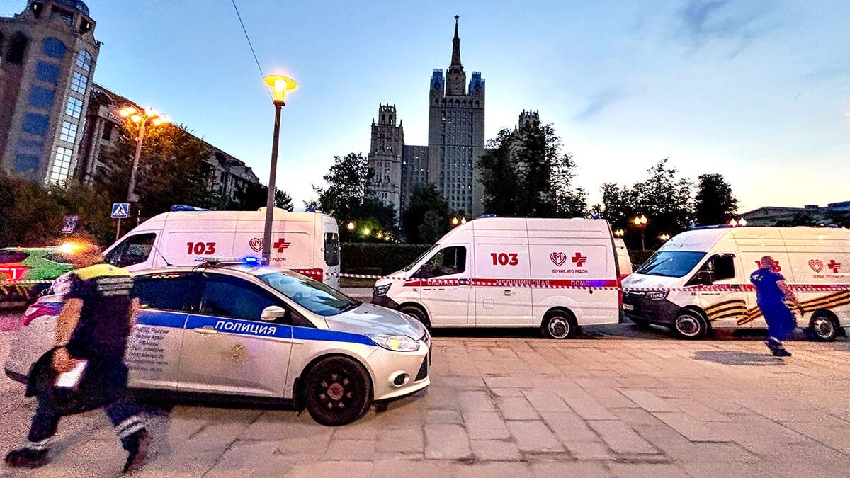 Emergency vehicles parked near a restaurant explosion site in Moscow.