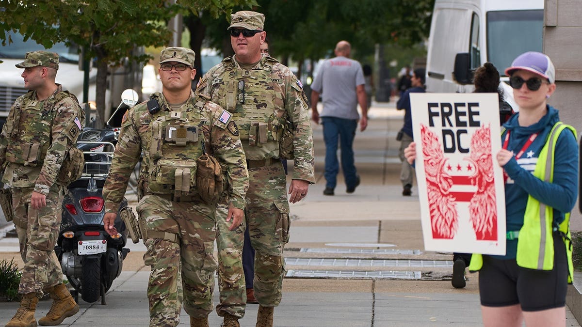 National Guard members patrol as Free DC protesters rally against their presence in Washington.