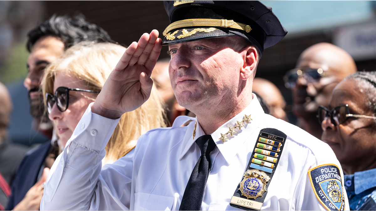 New York police officers stand together and salute.