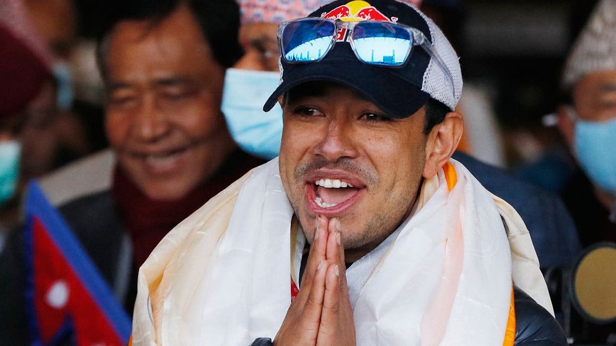 Nirmal Purja gestures as he arrives at Tribhuwan International Airport in Kathmandu.
