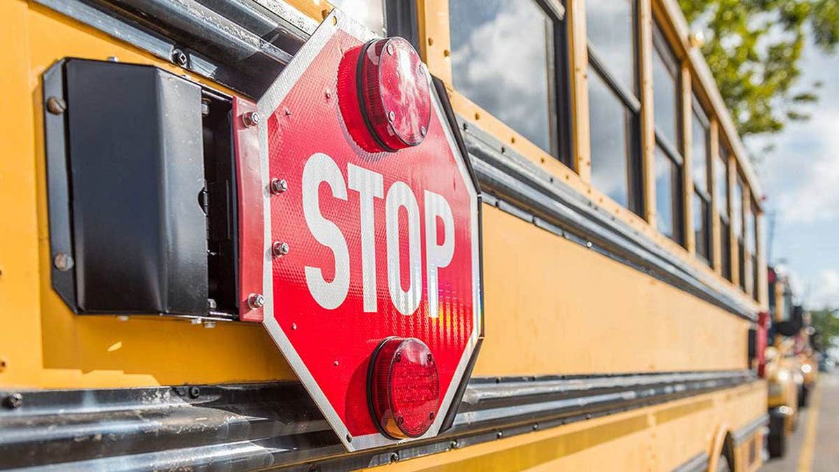 Stop sign visible on side of school bus