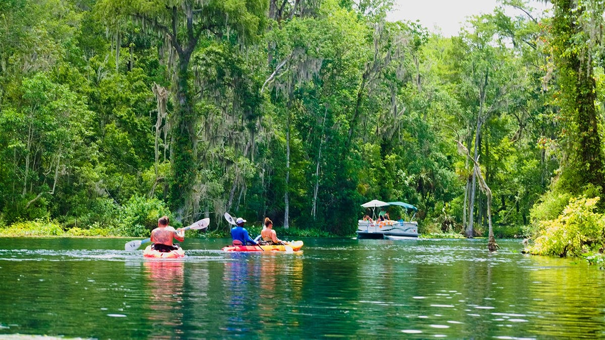 People kayak on Silver Springs in Florida.