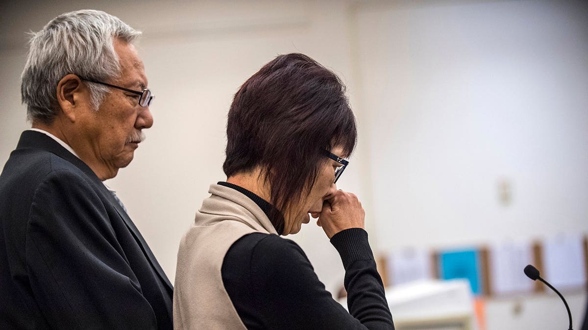 Junko Kibuishi speaks in Orange County Superior Court with her husband Masa beside her.