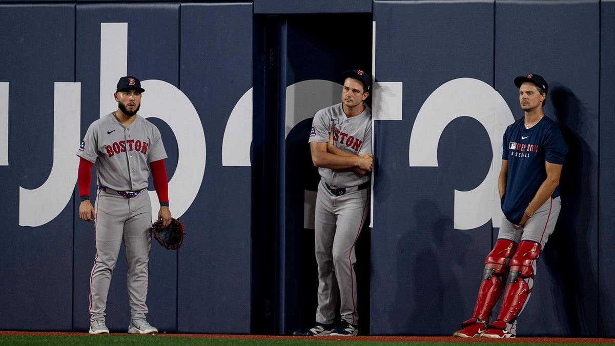 Wilyer Abreu, Garrett Whitlock and Charlie Madden react during a rules check at Rogers Centre.