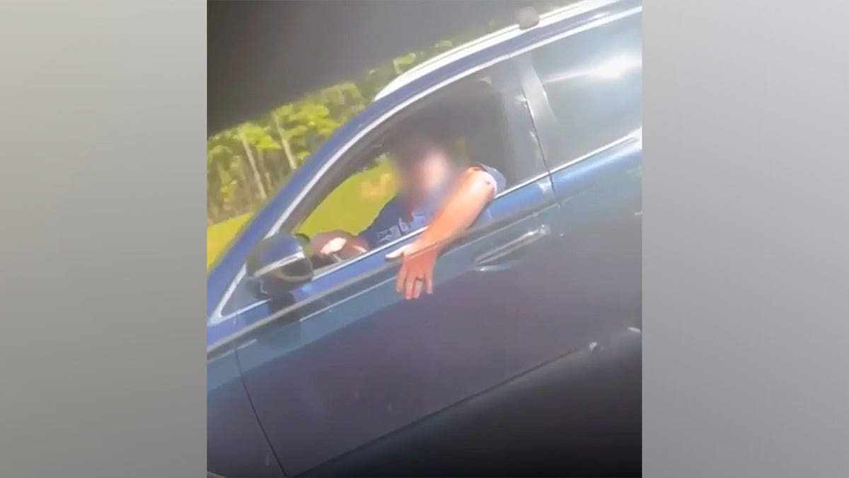 A driver gestures from a vehicle during a road rage incident in Greensboro.
