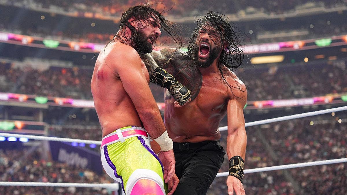 Roman Reigns wrestles Seth Rollins during SummerSlam at U.S. Bank Stadium.