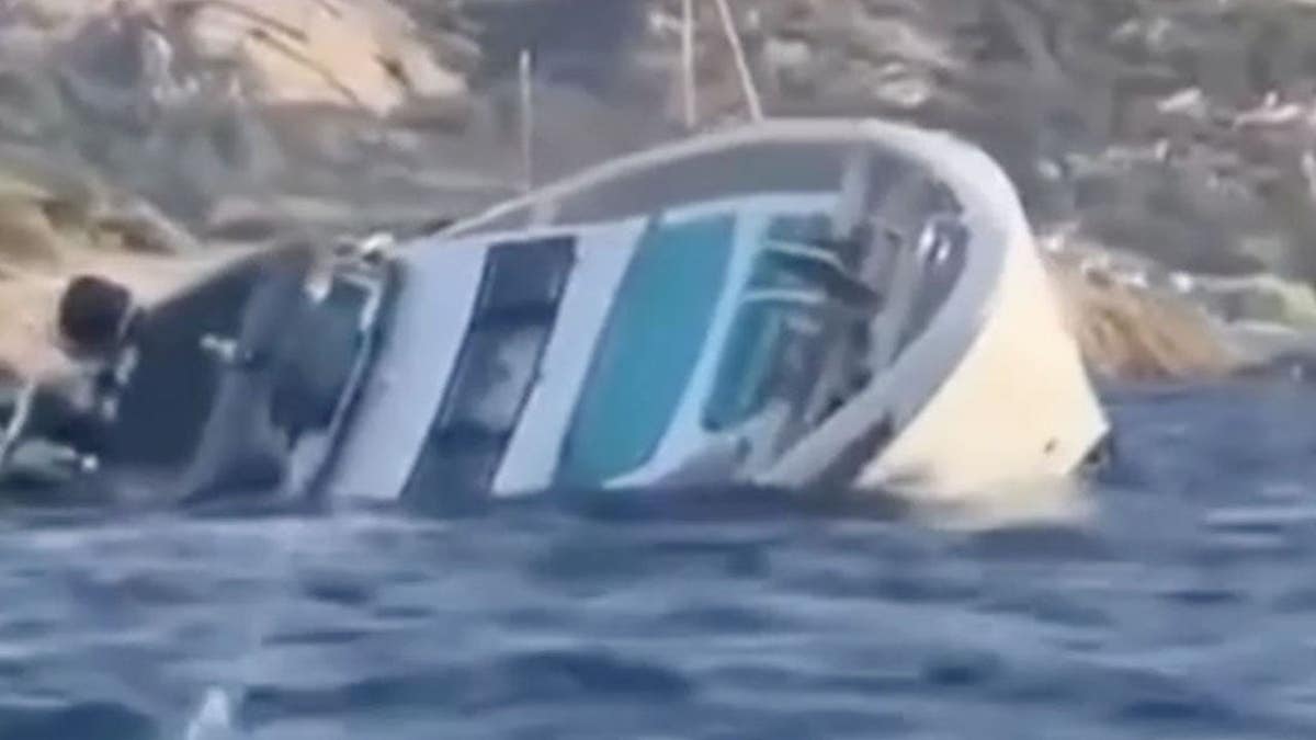 A superyacht rolls onto its side and sinks in Mediterranean waters off Sardinia.