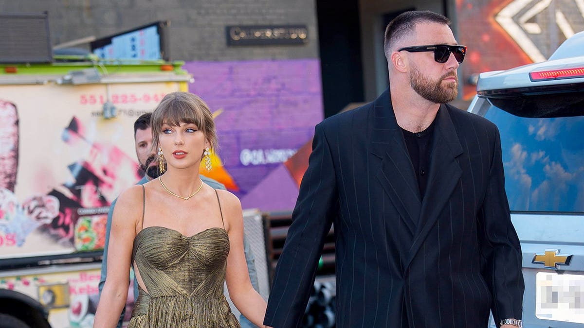 Taylor Swift and Travis Kelce walking together in New York City.