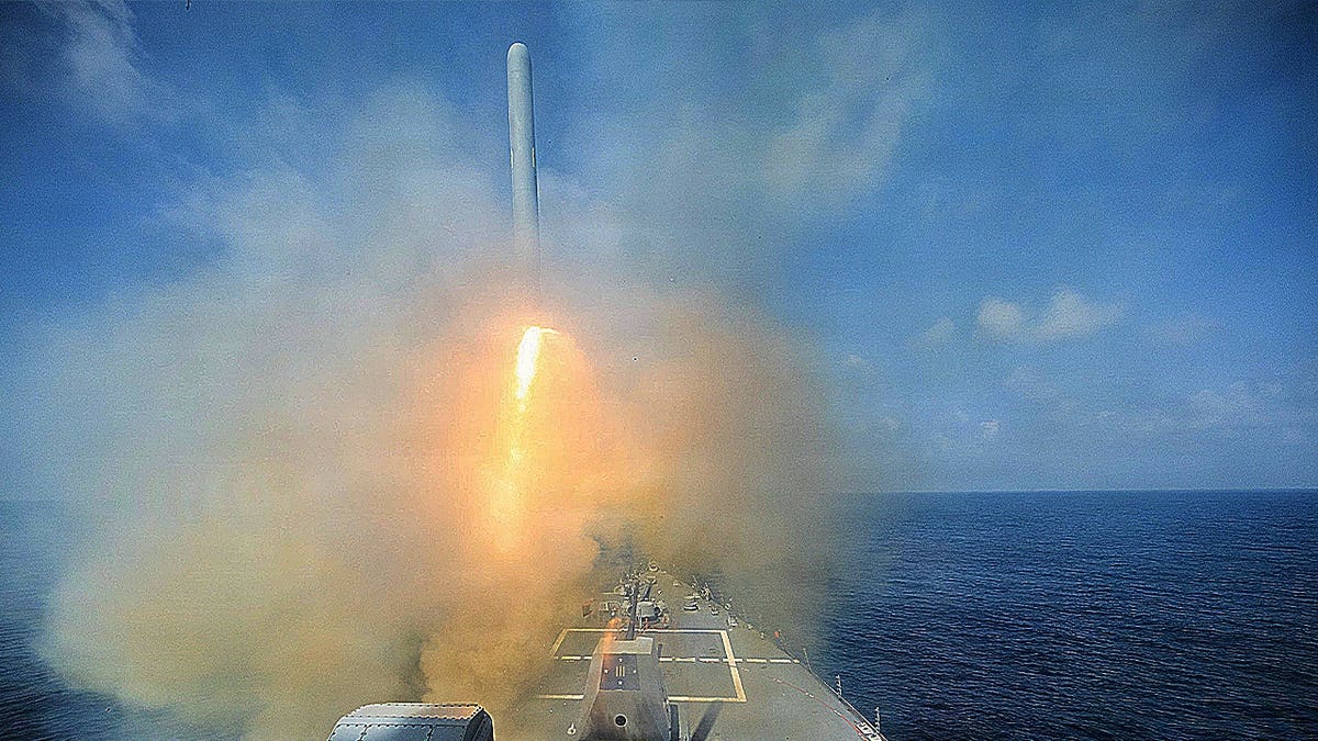 Arleigh Burke-class guided-missile destroyer fires Tomahawk
