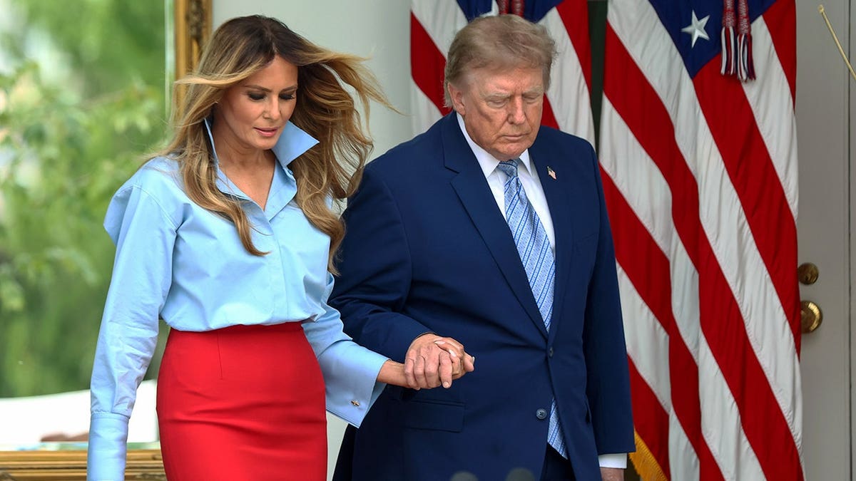 President Donald Trump and first lady Melania Trump arrive at the White House Rose Garden.