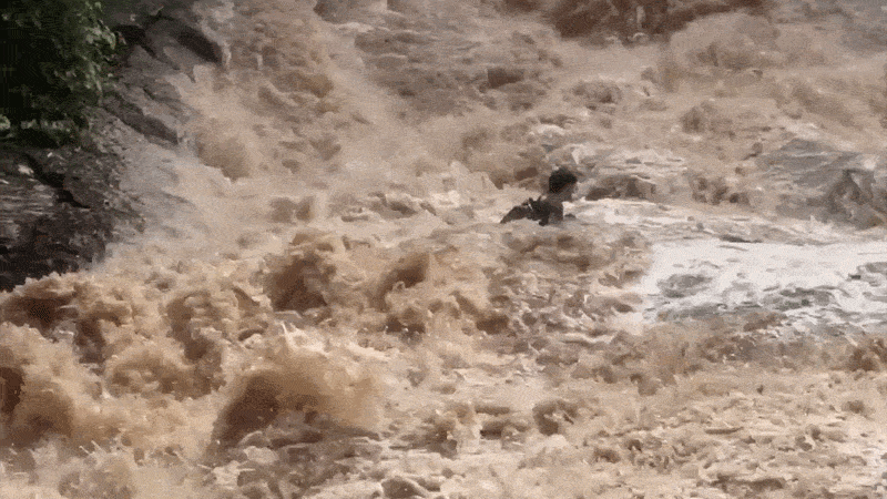 Tourists cling to each other in desperate struggle as raging flood sweeps them down waterfall Tourists cling to each other in desperate struggle as raging flood sweeps them down waterfall