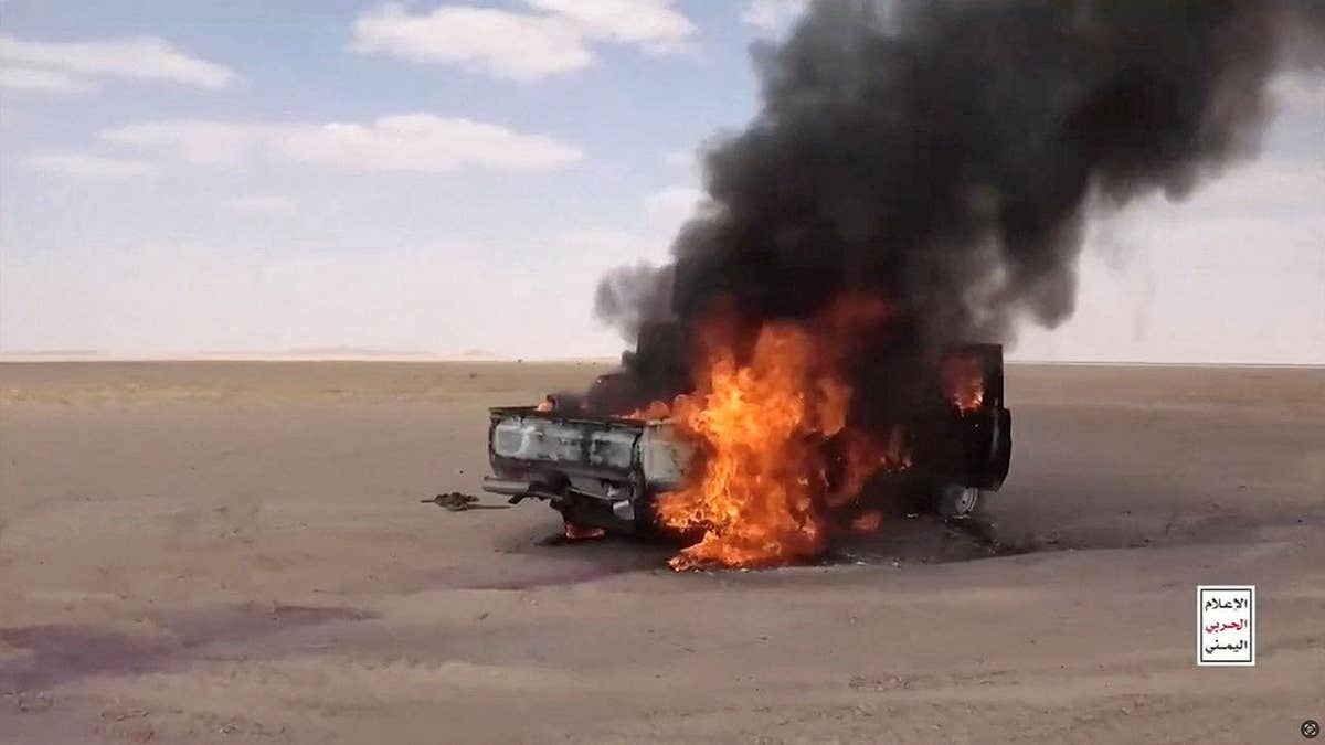 A vehicle burns after being attacked by Houthis