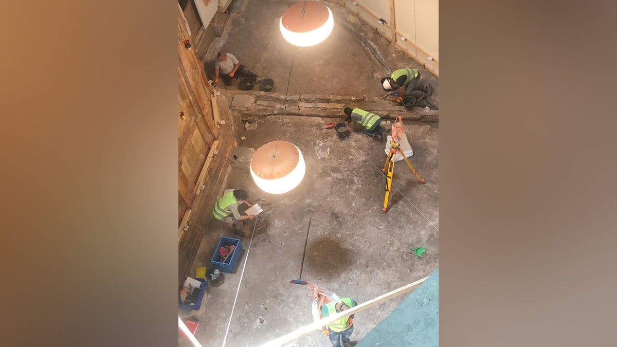 Archaeologists excavating area