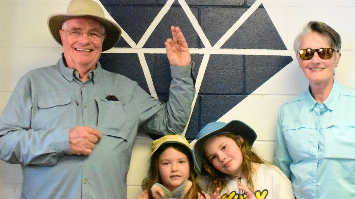 Smith holding his find next to his grandkids and wife