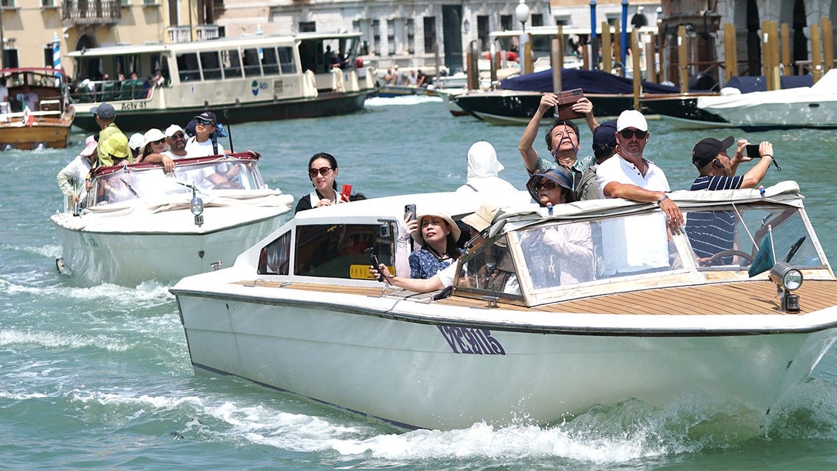 View of tourists on water taxi in Venice