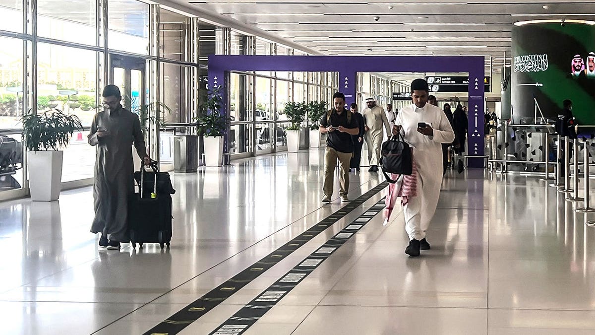 Men walking in Riyadh airport