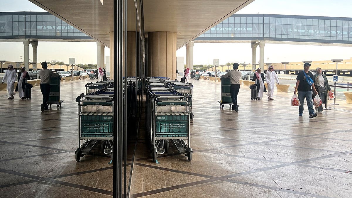 Travelers walking outside Riyadh airport
