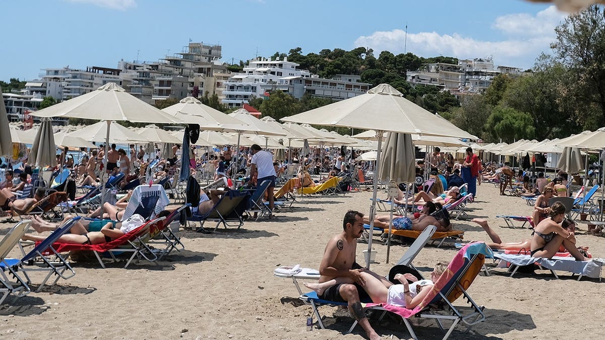 People relax at Akti Vouliagmenis beach resort in Vouliagmeni, Greece.