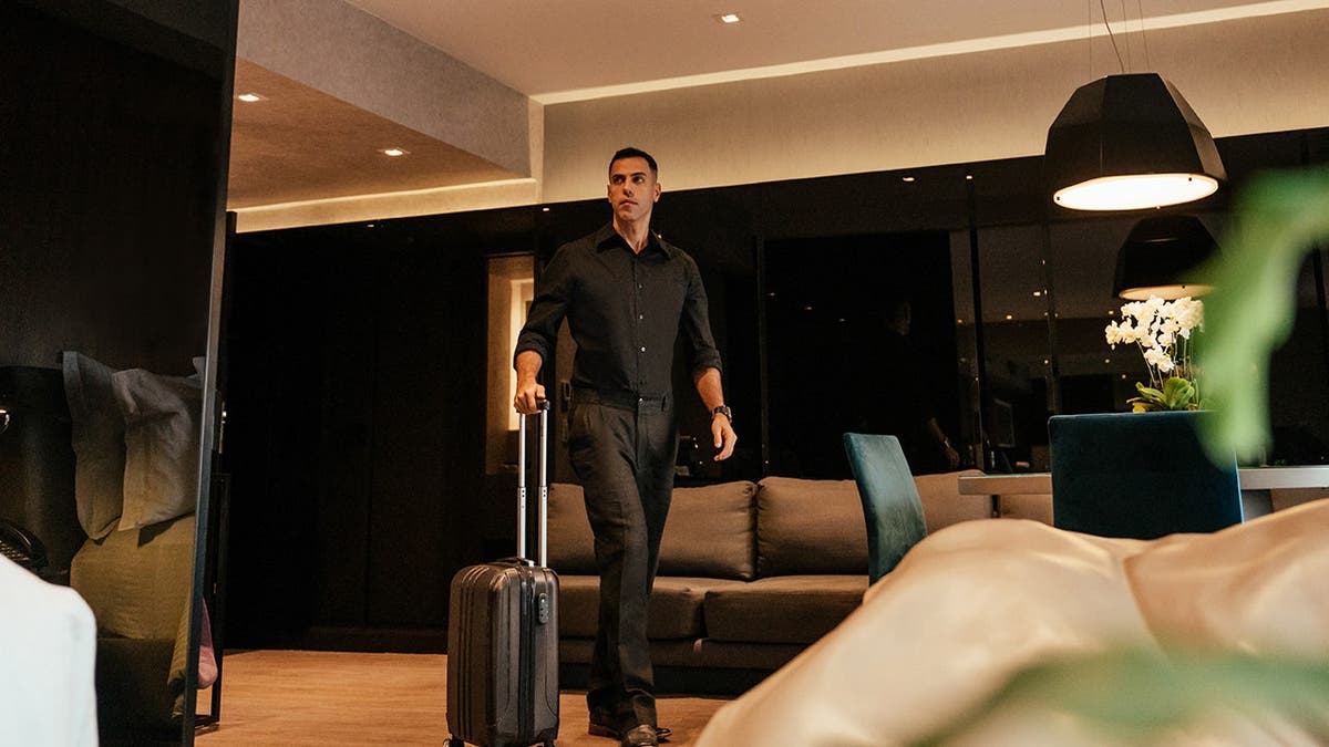 Businessman arriving at hotel room door.