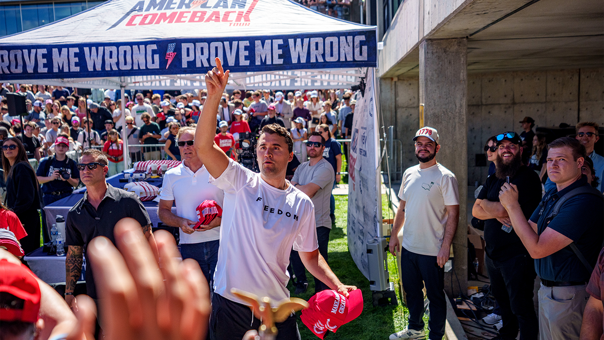Charlie Kirk at UVU in the courtyard throwing hats to the crowd in front of the TPUSA tent where he was later killed