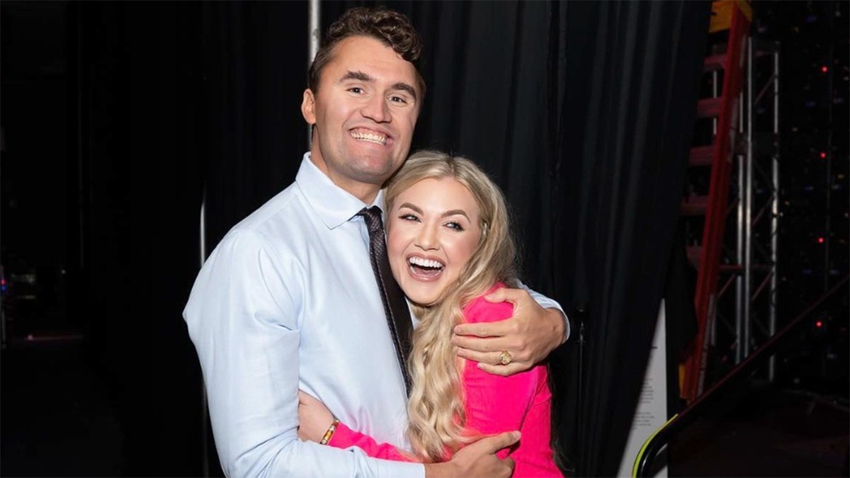 Charlie Kirk and his wife, Erika Lane Frantzve, pose together.