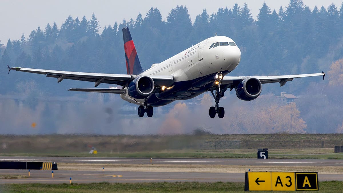 Delta Airlines Airbus A320 aircraft takes off from runway at Portland International Airport.