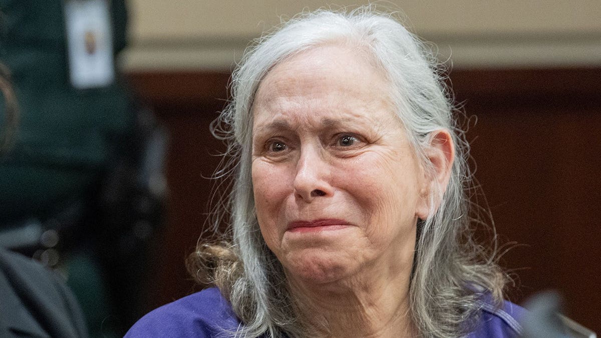 Donna Adelson looks toward Harvey Adelson during her sentencing.
