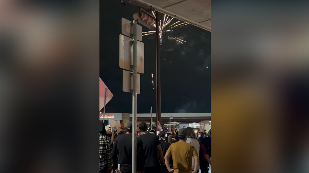Fireworks shooting off at an anti-ICE protest
