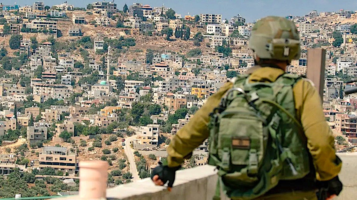 IDF soldier overlooking West Bank