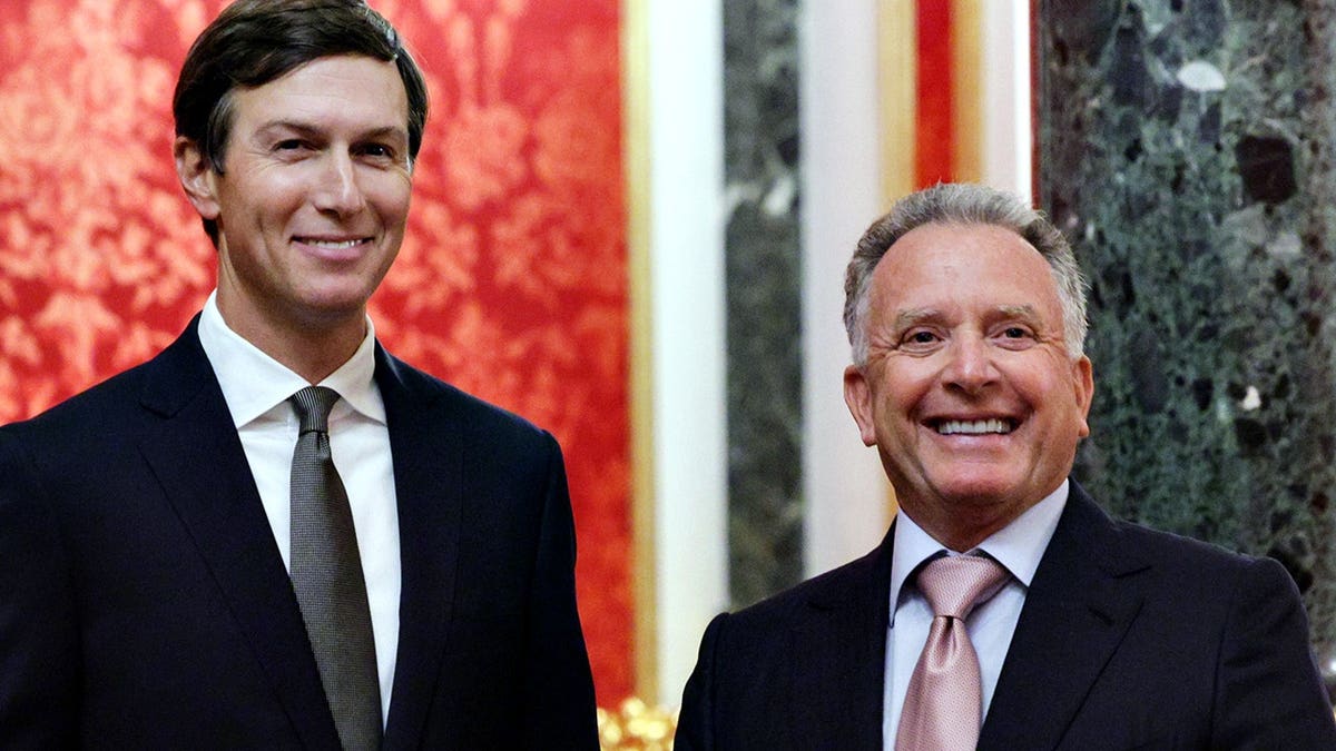 Jared Kushner and Steve Witkoff smile while waiting at the Kremlin in Moscow.