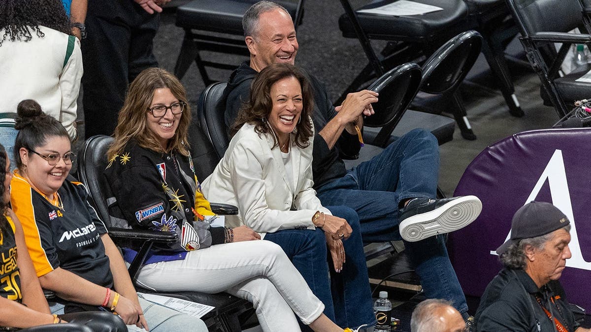 Kamala Harris and Douglas Emhoff sit courtside at a WNBA game.