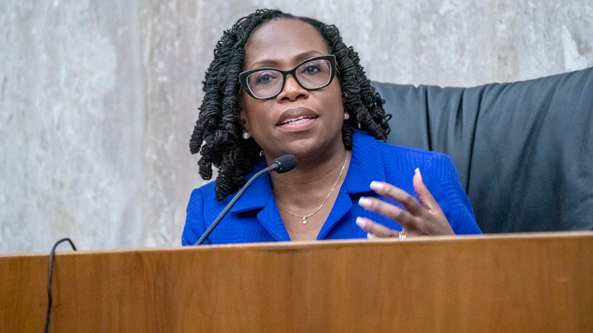 Ketanji Brown Jackson gives a lecture in a courtroom.