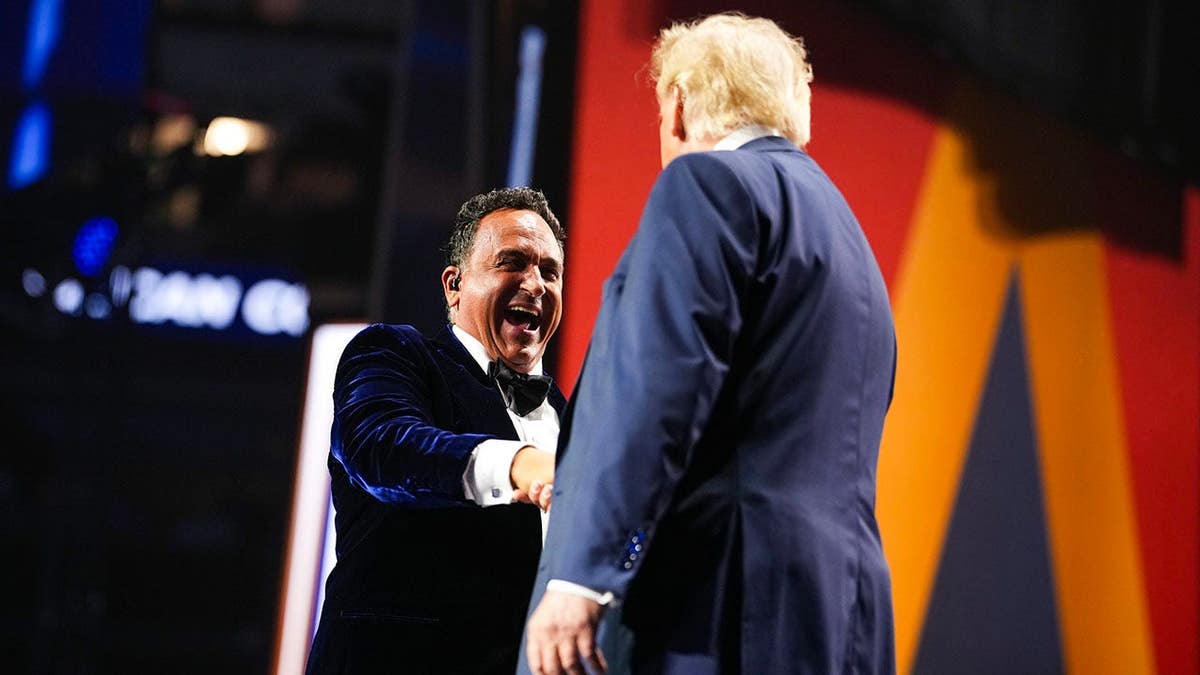 Donald Trump stands on stage with opera singer Christopher Macchio at the Republican National Convention.