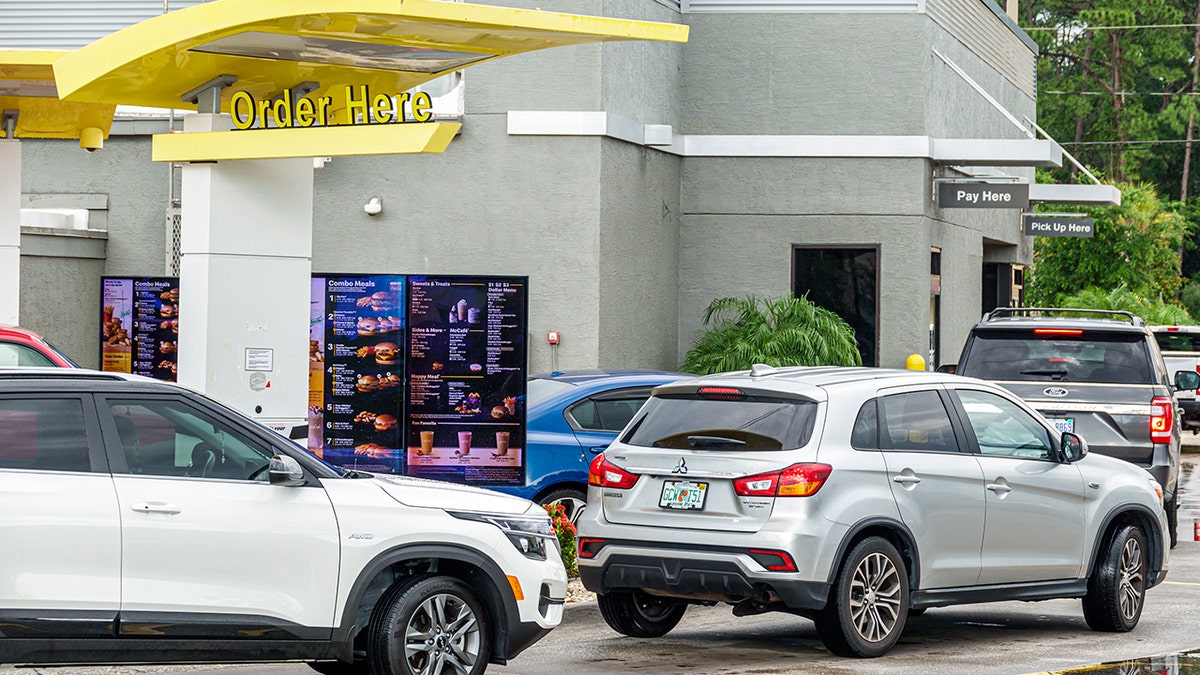 A line of vehicles in a McDonald's drive-thru.