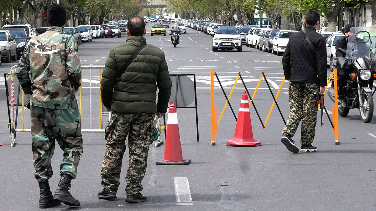 Members of the Basij paramilitary force standing at a checkpoint.