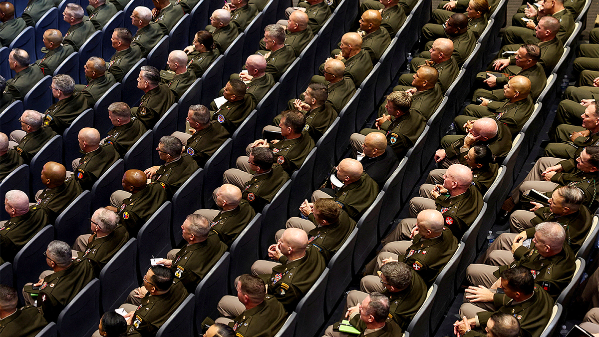 Members of the military attend a meeting