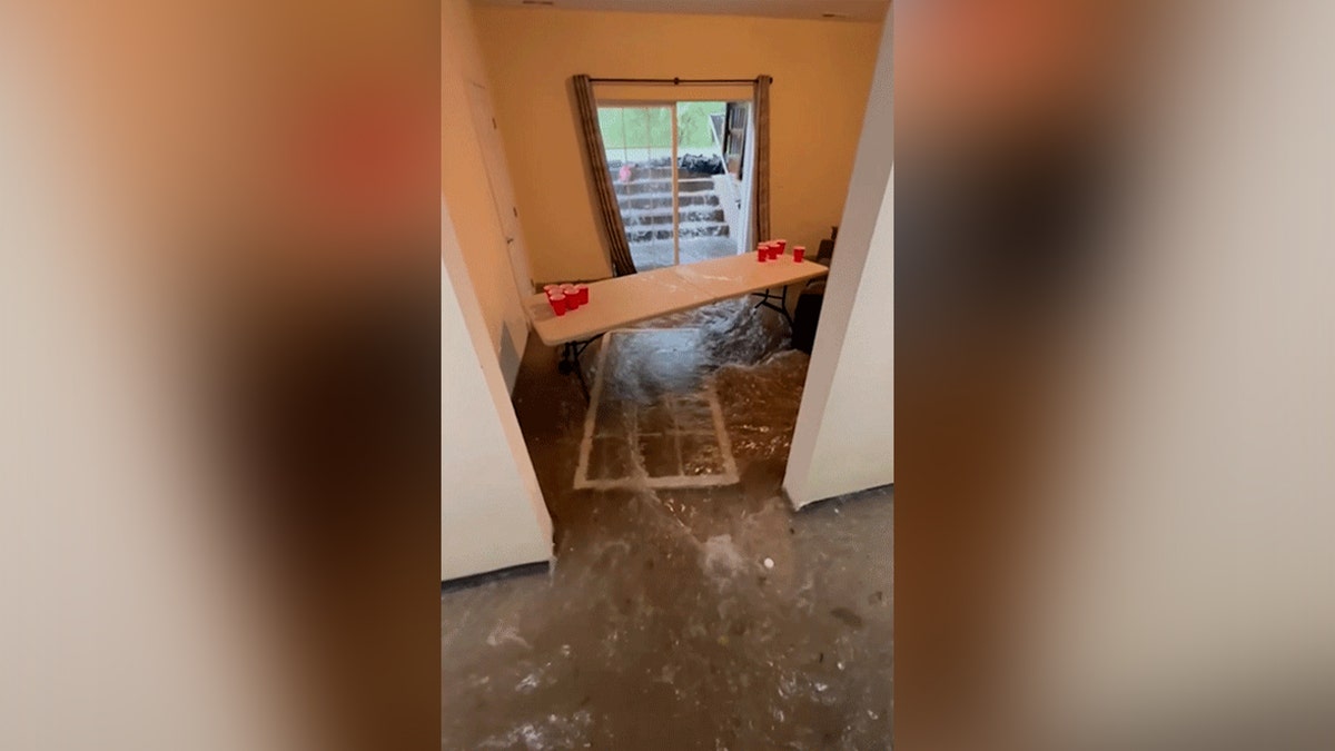 living room flooded with door open