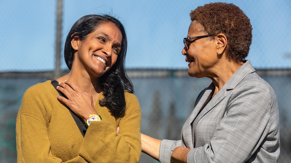 Two Los Angeles city officials speak together at a neighborhood park before a campaign event.