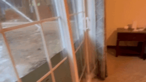 Dramatic video captures floodwaters bursting through glass doors of college students’ home