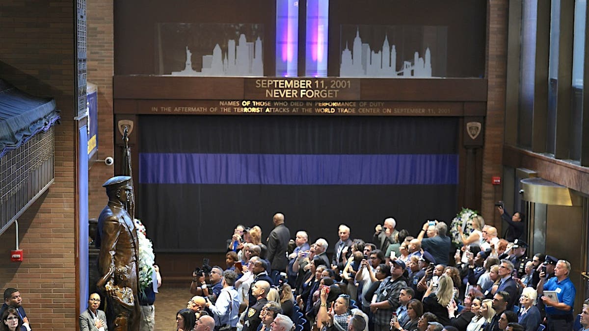 People gather at One Police Plaza for a 9/11 Memorial Wall unveiling ceremony in New York City.
