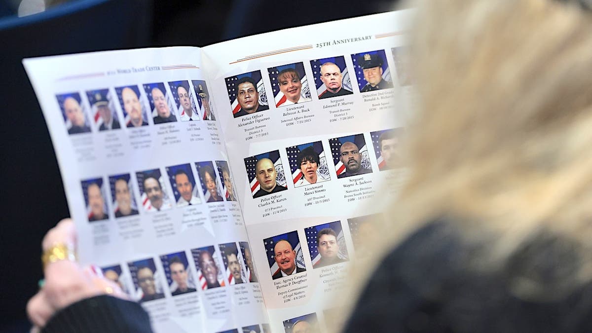People attend a 9/11 Memorial Wall unveiling ceremony at One Police Plaza in New York City.