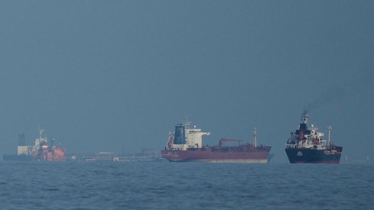 Oil tankers and cargo ships lining up in the Strait of Hormuz.