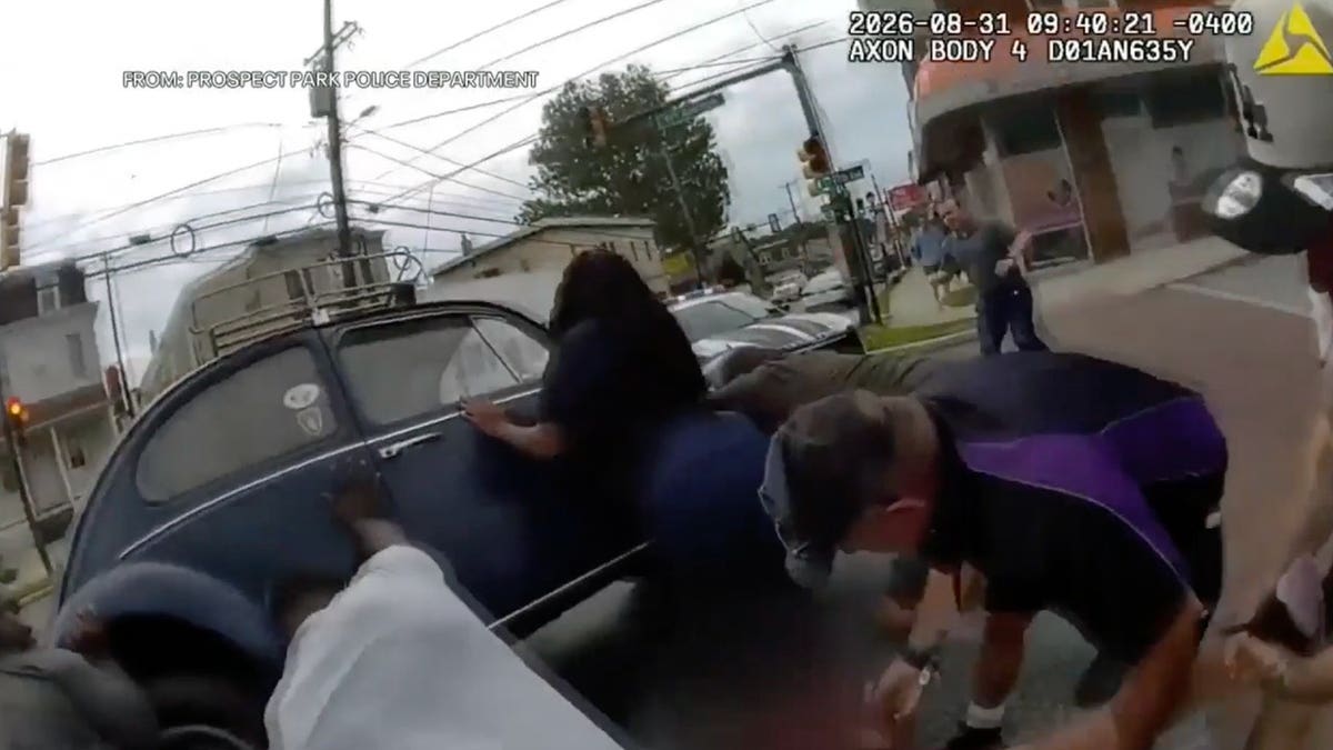 Police body camera video shows bystanders rushing to help lift a car off a 44-year-old e-bike rider