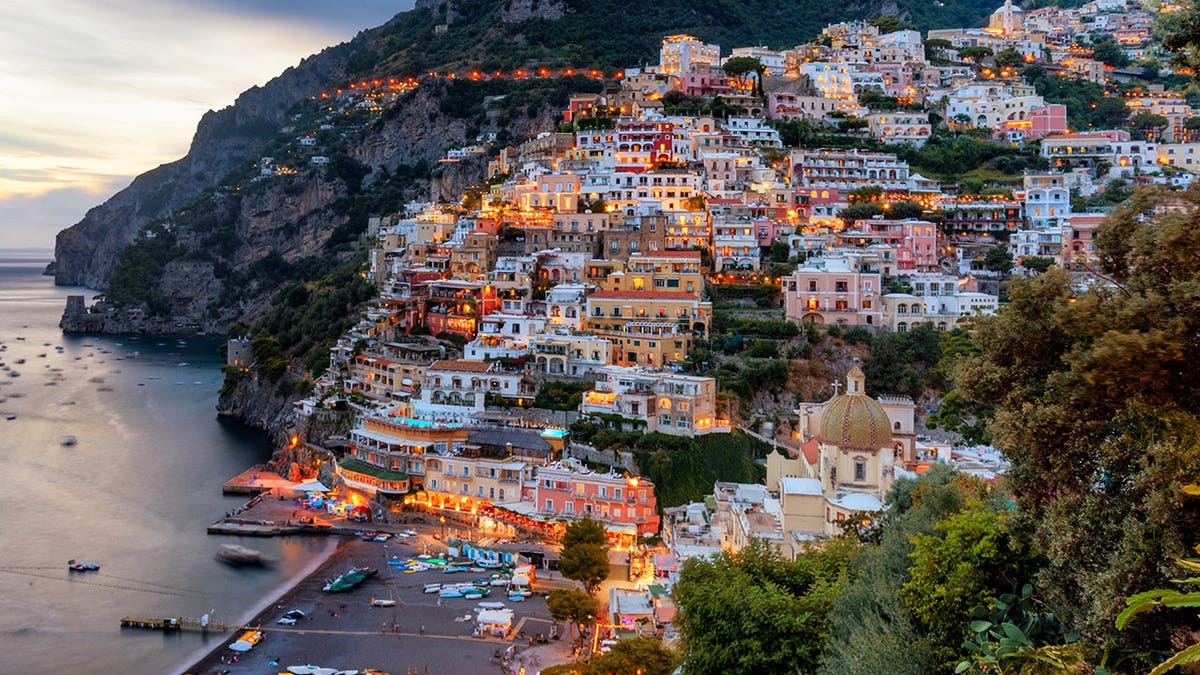 Positano village with colorful buildings clinging to cliffs overlooking the Mediterranean Sea.
